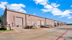 Up-close view of the backside of the Avion Business Park with multiple garage doors, loading docks, and truck ramps